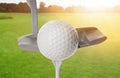 Hitting golf ball with club on sunny day Royalty Free Stock Photo