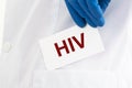 HIV acronym - Human Immunodeficiency Virus - word on paper in doctor hands as medical concept