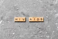 HIV AIDS word written on wood block. HIV AIDS text on cement table for your desing, concept