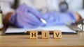 HIV text on cubes in medical clinic against background of doctor