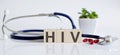 HIV the word is written on wooden cubes and sthetoscope and piils . Medical concept