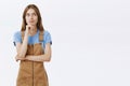 Hmm I wonder what cook today. Portrait of creative good-looking thoughtful young caucasian female in brown overalls