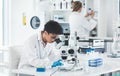 Hmm this is an interesting finding. an attractive young female scientist looking through a microscope in a laboratory Royalty Free Stock Photo