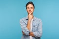 Hmm, let`s think! Portrait of pensive handsome man in worker denim shirt touching chin while pondering plan