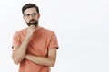 Hmm need think up plan. Portrait of determined and thoughtful creative perplexed guy smirking rubbing beard thoughtful Royalty Free Stock Photo