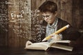 Hmm, this is a tricky problem...a young boy doing his maths homework. Royalty Free Stock Photo