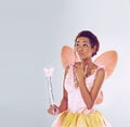 Hmm, what wishes should I grant next. A cropped shot of a cute fairy looking thoughtful. Royalty Free Stock Photo