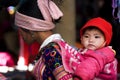 Hmong woman with her child on back