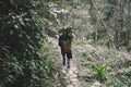 Hmong women is carrying blanket on the way home at SAPA, Northern Vietnam. North Vietnamese woman carries a basket with leaves