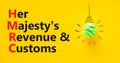 HMRC her majestys revenue and customs symbol. Concept words HMRC her majestys revenue and customs on beautiful yellow background.