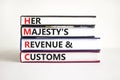HMRC her majestys revenue and customs symbol. Concept words HMRC her majestys revenue and customs on books on beautiful white