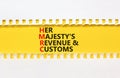 HMRC her majestys revenue and customs symbol. Concept words HMRC her majestys revenue and customs on beautiful white and yellow