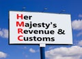 HMRC her majestys revenue and customs symbol. Concept words HMRC her majestys revenue and customs on billboard against blue sky