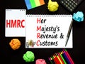 HMRC her majestys revenue and customs symbol. Concept words HMRC her majestys revenue and customs on white note on beautiful black