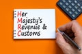 HMRC her majestys revenue and customs symbol. Concept words HMRC her majestys revenue and customs on white note on beautiful