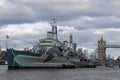 HMS Belfast military ship, town-class light cruiser under cloudy sky in London, UK