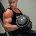 Hnadsome young man working out with dumbbells in fitness - powe Royalty Free Stock Photo