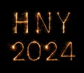 2024 (HNY) happy new year fireworks celebration written sparkling at night Royalty Free Stock Photo