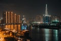 Ho Chi Minh city at night, Elisa Sailboat, a floating restaurant, Far away is landmark 81 skyscraper and Thu Thiem peninsula Royalty Free Stock Photo