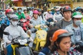 Ho Chi Minh City, Vietnam: people on motorbikes wait for the traffic light at the busy intersection during the rush hour Royalty Free Stock Photo