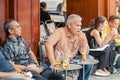 HO CHI MINH CITY, VIETNAM - APRIL 24, 2019 : Unidentified people drink coffee, tea or juice fruit on cafe stall on sidewalk on