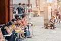 HO CHI MINH CITY, VIETNAM - APRIL 24, 2019 : Unidentified people drink coffee, tea or juice fruit on cafe stall on sidewalk on