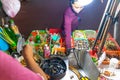 Vietnamese woman selling seafood on the counter and Snail`s for sale in a night market in Ho Chi Minh city Saigon, Vietnam. Foo