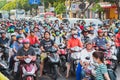 Ho Chi Minh City, Vietnam: a crowd on motorbikes wait for the traffic light at the busy intersection during the rush hour Royalty Free Stock Photo