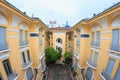 Ho Chi Minh city, Vietnam - December 2018: inner yard with green trees and cloudy sky in Ho Chi Minh city museum. Royalty Free Stock Photo