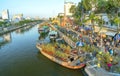 Flowers boat at flower market along canal wharf