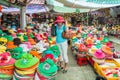 A woman tourists tries on a hat