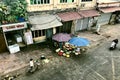 Ho Chi Minh City, Vietnam - February 9, 2019: woman and little boy sell fresh vegetables on the sidewalk in urban slums.