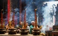 HO CHI MINH CITY, VIETNAM - JANUARY 5. 2015: Buddhist believers light incense sticks in pots in chinese temple. Massive fume in