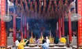 HO CHI MINH CITY, VIETNAM - JANUARY 5. 2015: Inside Buddhist temple with hanging spiral incense coils and burning sticks with Royalty Free Stock Photo