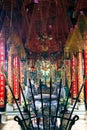 HO CHI MINH CITY, VIETNAM - JANUARY 5. 2015: Inside Buddhist temple with hanging spiral incense coils and burning sticks with