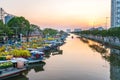 Flower boats full of flowers parked along canal wharf in sunset Royalty Free Stock Photo