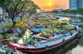 Flower boats full of flowers parked along canal wharf in sunset Royalty Free Stock Photo