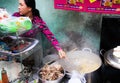 Woman cooking traditional vietnamese street food outdoor in pots Royalty Free Stock Photo