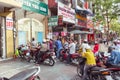 Ho Chi Minh City, Vietnam: a line of people on motorbikes waits for the end of lessons to pick up children Royalty Free Stock Photo