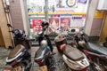 Ho Chi Minh City, Vietnam - May 3, 2019: inconveniently parked motorbikes block the entrance door of a convenience store