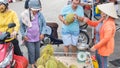 Ho Chi Minh City, Vietnam: a man buys a durian at a street vendor`s place at a street market Royalty Free Stock Photo