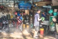 Ho Chi Minh City, Vietnam: men work at a small motorbike wash Royalty Free Stock Photo