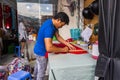 A man mark the fabric to make a traditional ao dai dress