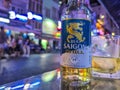 Ho Chi Minh City, Vietnam - Close-up of a cold Bia Saigon Chill beer on a table with blurred, colorful night life