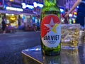 Ho Chi Minh City, Vietnam - Close-up of a cold Bia Viet beer bottle at an outdoor pub on bustling Bui Vien Street