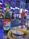 Ho Chi Minh City, Vietnam - Close-up of a cold bottle of Bia Viet cold beer with snacks at an outdoor pub, with