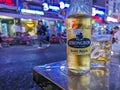 Ho Chi Minh City, Vietnam - Close-up of a cold bottle of Strongbow apple cider Gold Apple at a bustling outdoor pub