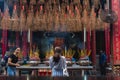 Ho Chi Minh City, Vietnam: worshipers and travelers in Thien Hau Pagoda, with hanging spiral incense sticks Royalty Free Stock Photo