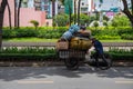 Ho Chi Minh, Vietnam - 30 Jul 2019: Poor man with garbage cart on city street. Paper waste recycle Royalty Free Stock Photo