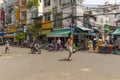 Local Vietnamese people walking on the street near Hoa Binh Market in Ho Chi Minh City, Vietnam Royalty Free Stock Photo
